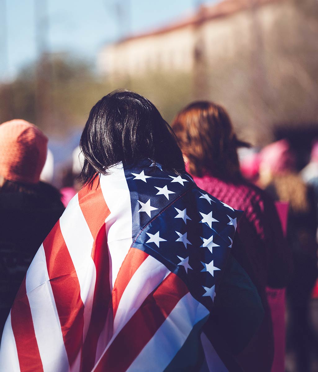 Person Carrying American Flag over their Back